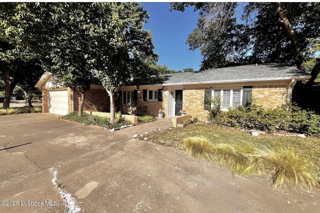 7907 Knoxville Ave, Lubbock, TX 79423 - ranch-style home featuring brick siding, an attached garage, and concrete driveway