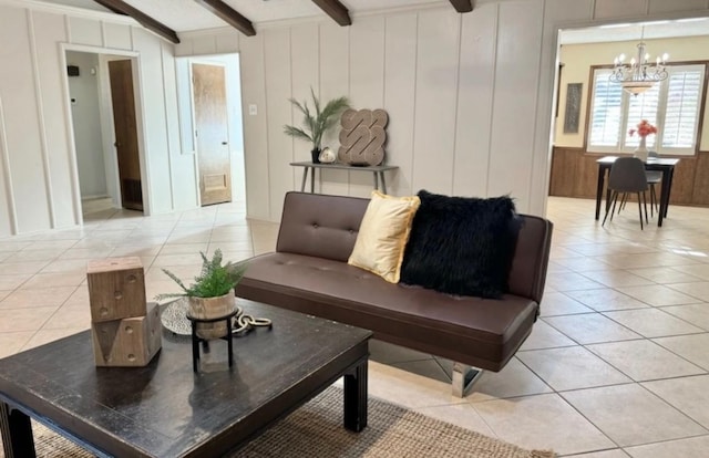 living room with light tile patterned floors, beam ceiling, and a chandelier