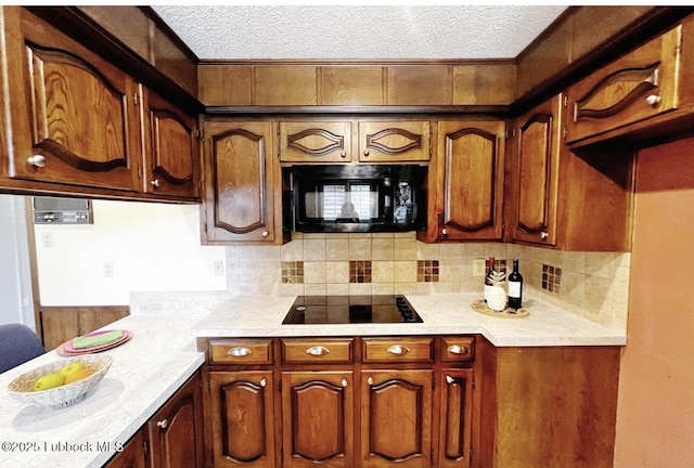 7907 Knoxville Ave, Lubbock, TX 79423 - kitchen with black appliances, light countertops, a textured ceiling, and backsplash