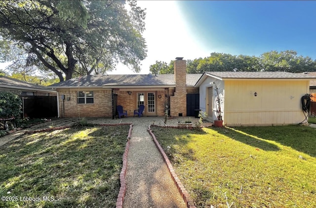 7907 Knoxville Ave, Lubbock, TX 79423 - back of house with a chimney, a patio, and brick siding