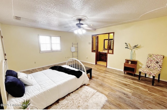 7907 Knoxville Ave, Lubbock, TX 79423 - bedroom with a textured ceiling, wood finished floors, and baseboards