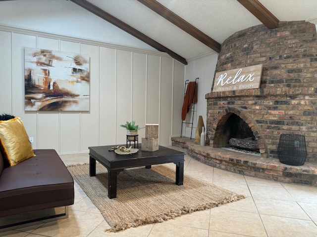 living room featuring a brick fireplace, light tile patterned floors, a textured ceiling, and vaulted ceiling with beams