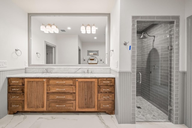 bathroom featuring vanity and a shower with door