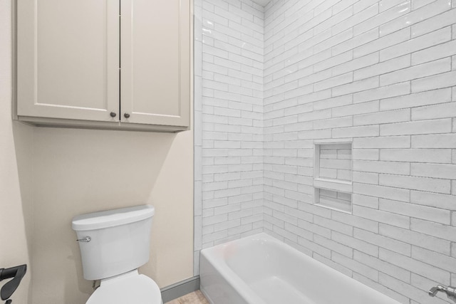 bathroom with tiled shower / bath combo and toilet