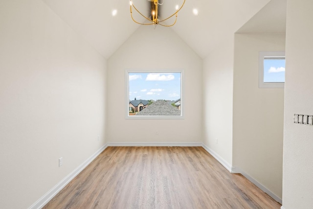 bonus room featuring lofted ceiling, light hardwood / wood-style flooring, and a notable chandelier