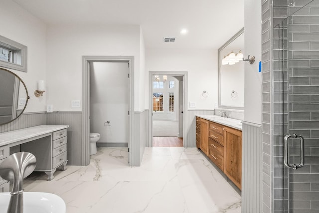 bathroom with vanity, toilet, and walk in shower