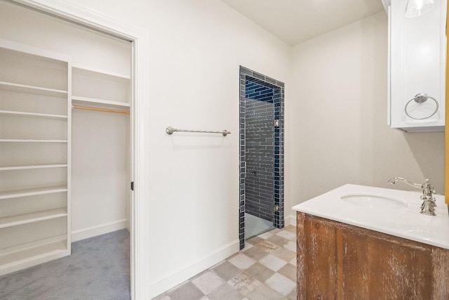 bathroom with vanity and a tile shower