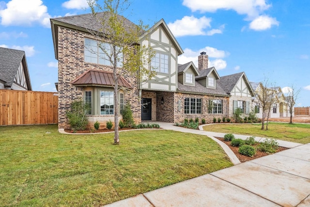 tudor home with a front lawn