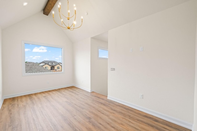 empty room featuring lofted ceiling with beams, light hardwood / wood-style floors, and a chandelier