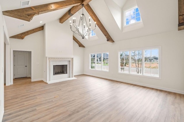 unfurnished living room featuring beamed ceiling, an inviting chandelier, high vaulted ceiling, and light hardwood / wood-style flooring