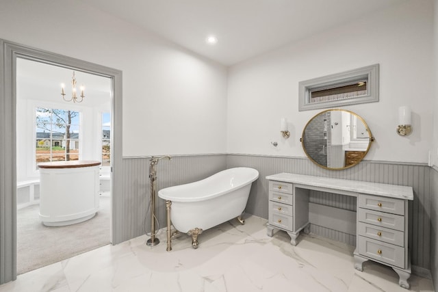 bathroom featuring a tub to relax in and a notable chandelier