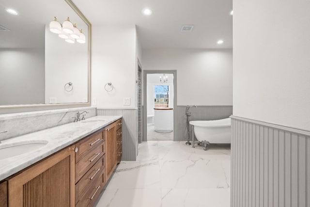 bathroom featuring vanity and a tub