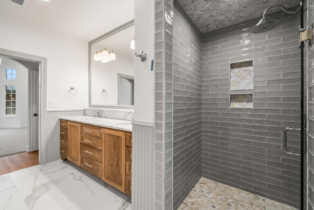 bathroom featuring vanity and an enclosed shower