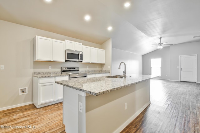 2012 Kenwood Ave, Lubbock, TX 79407 - kitchen with appliances with stainless steel finishes, light wood-type flooring, white cabinets, a ceiling fan, and lofted ceiling