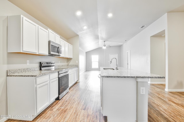 2012 Kenwood Ave, Lubbock, TX 79407 - kitchen with stainless steel appliances, lofted ceiling, light wood-type flooring, white cabinetry, and ceiling fan