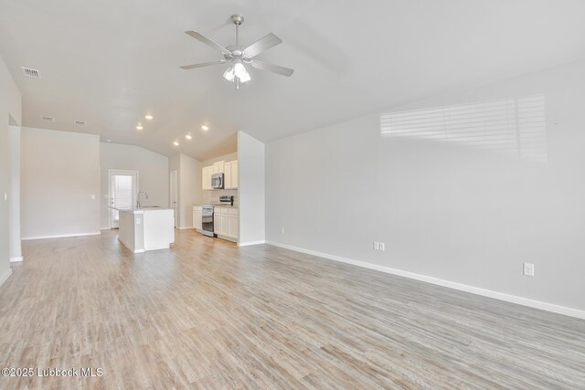 2012 Kenwood Ave, Lubbock, TX 79407 - unfurnished living room featuring vaulted ceiling, a ceiling fan, light wood-type flooring, and recessed lighting