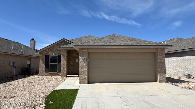 2012 Kenwood Ave, Lubbock, TX 79407 - view of front of house with brick siding, concrete driveway, an attached garage, and roof with shingles
