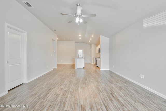 2012 Kenwood Ave, Lubbock, TX 79407 - unfurnished living room featuring lofted ceiling, ceiling fan, and light wood-type flooring