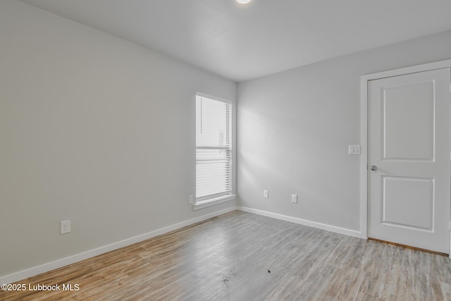 2012 Kenwood Ave, Lubbock, TX 79407 - unfurnished room with baseboards and light wood-style floors