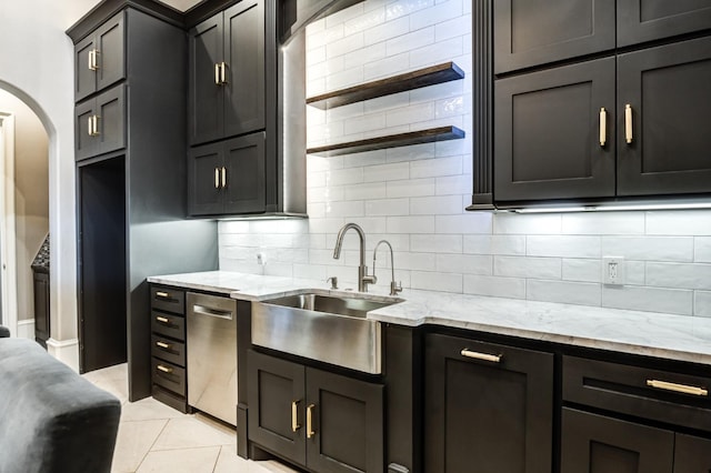 kitchen with sink, light stone counters, tasteful backsplash, light tile patterned floors, and dishwasher