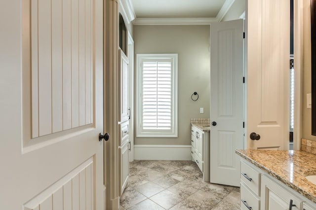 bathroom with crown molding and vanity