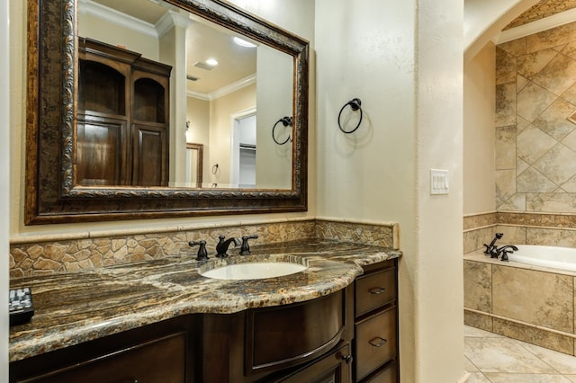 bathroom with crown molding, vanity, and tiled bath