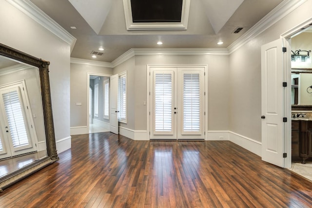 entryway with crown molding, dark hardwood / wood-style floors, a tray ceiling, a wealth of natural light, and french doors