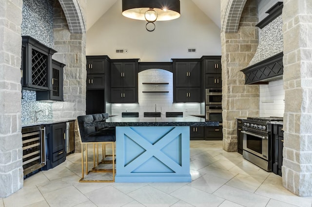 kitchen with backsplash, high vaulted ceiling, stainless steel appliances, wine cooler, and a kitchen island