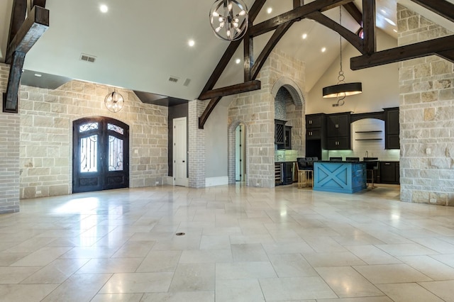 interior space with an inviting chandelier, high vaulted ceiling, french doors, and beamed ceiling