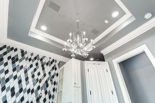 room details featuring ornamental molding and a raised ceiling