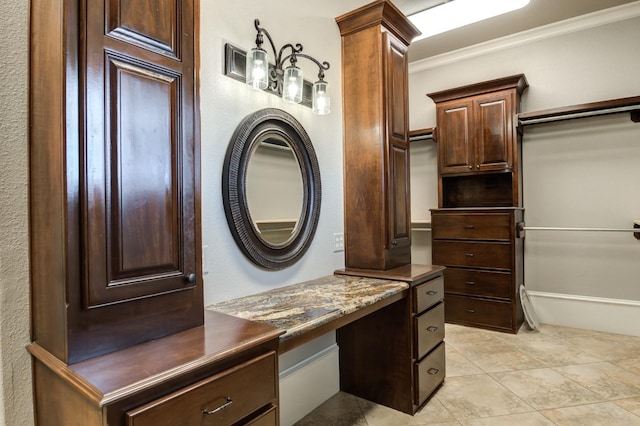 bathroom featuring tile patterned flooring, ornamental molding, and vanity