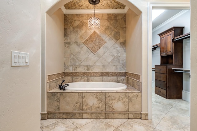 bathroom featuring ornamental molding and a relaxing tiled tub