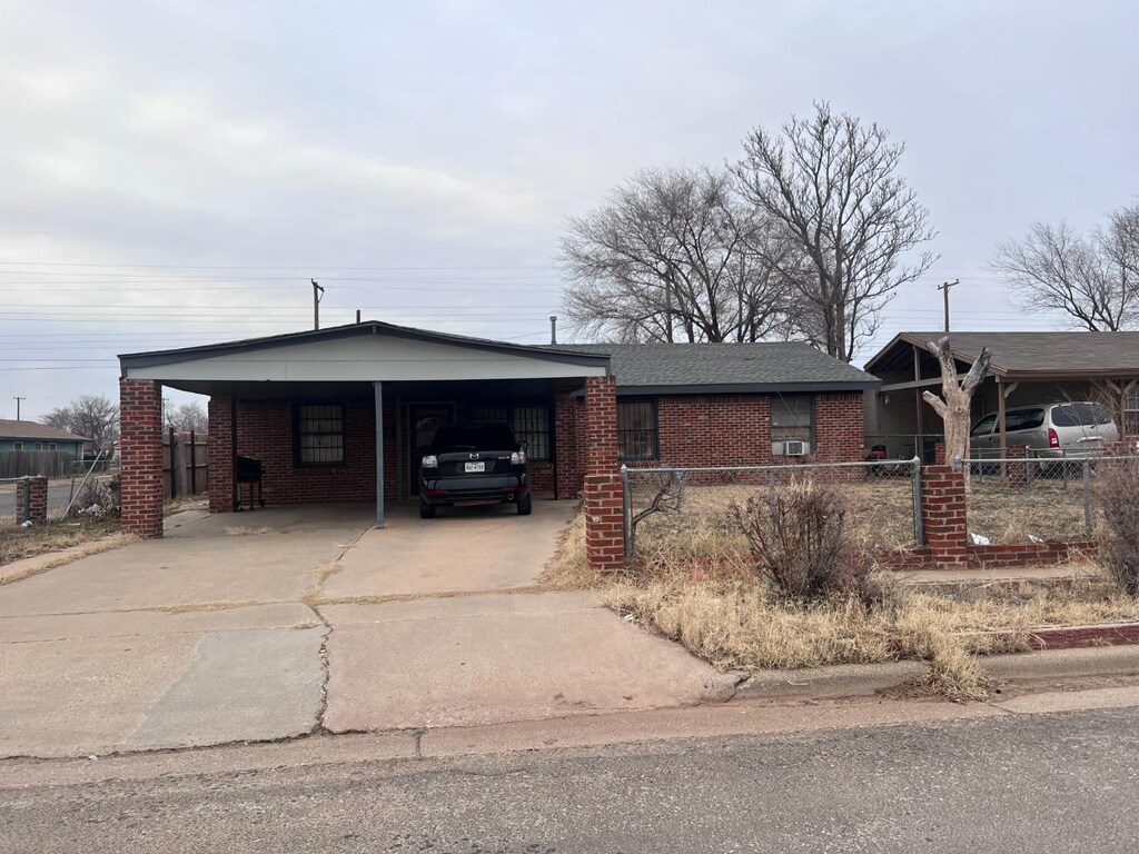 ranch-style home featuring a carport