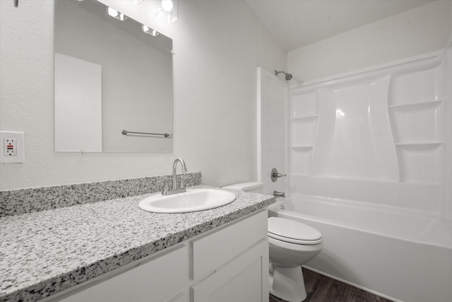 full bathroom featuring hardwood / wood-style flooring, vanity, toilet, and shower / bath combination