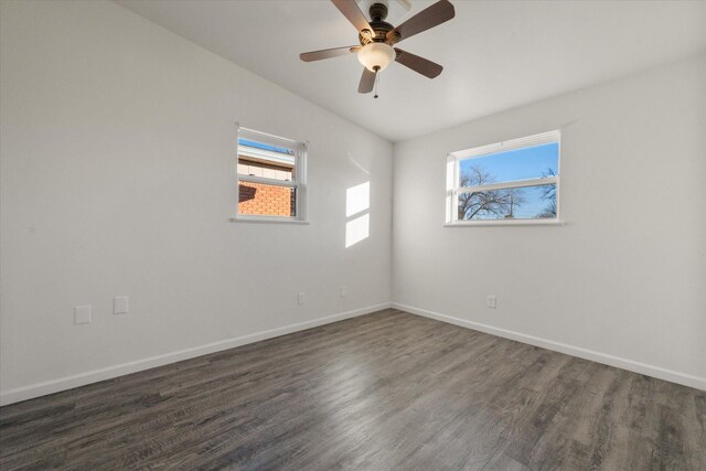 spare room with ceiling fan and dark hardwood / wood-style flooring