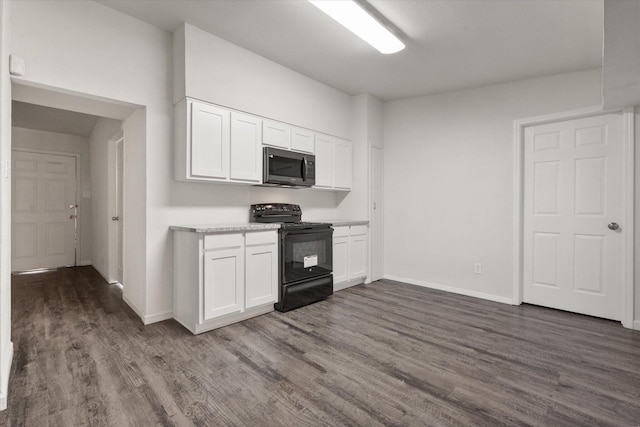 kitchen with white cabinetry, electric range, and dark hardwood / wood-style flooring