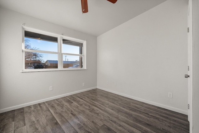 spare room featuring ceiling fan and dark hardwood / wood-style flooring