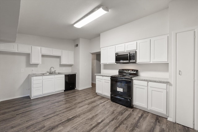 kitchen with white cabinetry, sink, dark wood-type flooring, and black appliances