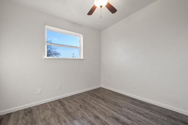 empty room with ceiling fan and dark hardwood / wood-style flooring