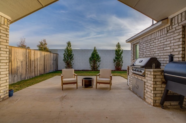 view of patio / terrace featuring an outdoor kitchen and a grill