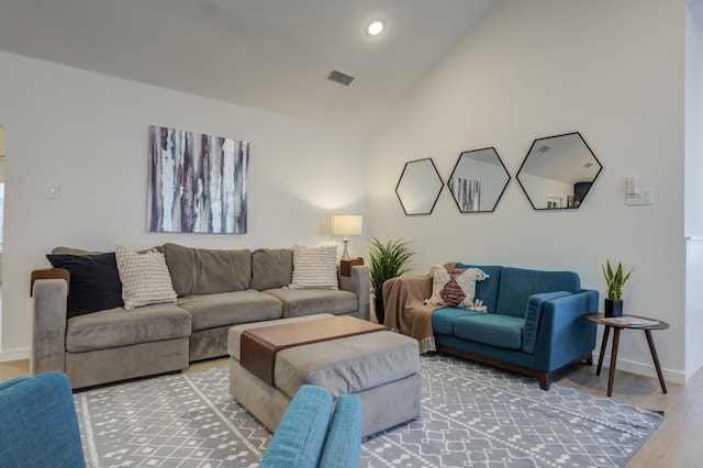 living room with hardwood / wood-style flooring and vaulted ceiling