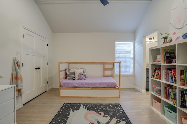 bedroom with lofted ceiling and light hardwood / wood-style floors