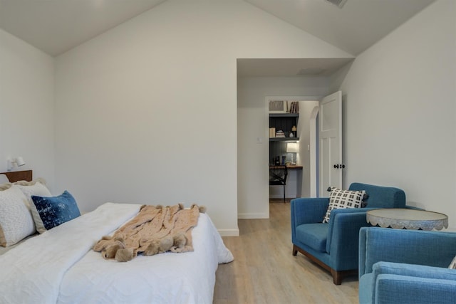 bedroom featuring vaulted ceiling and light hardwood / wood-style flooring