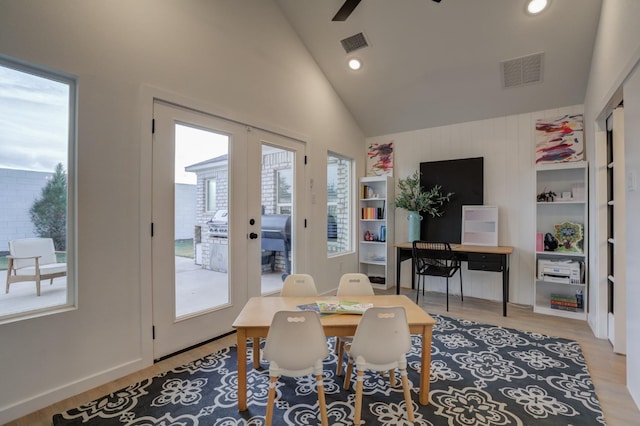 interior space featuring high vaulted ceiling, french doors, ceiling fan, and light wood-type flooring