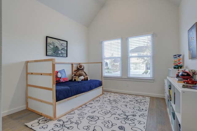 bedroom with lofted ceiling and light hardwood / wood-style flooring