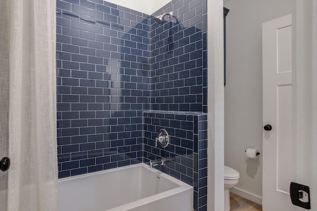 bathroom featuring hardwood / wood-style flooring, shower / bathtub combination with curtain, and toilet