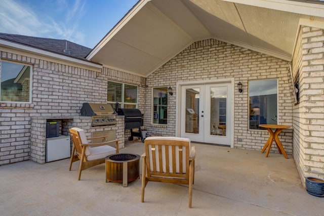 view of patio with an outdoor kitchen, grilling area, and french doors