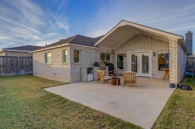 back of house featuring area for grilling, a yard, a patio, and french doors