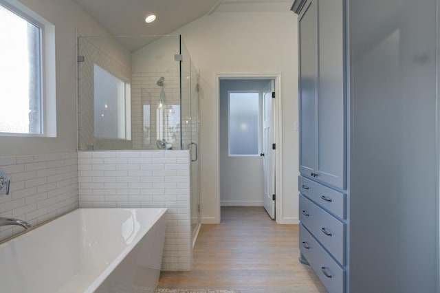 bathroom with shower with separate bathtub and hardwood / wood-style floors