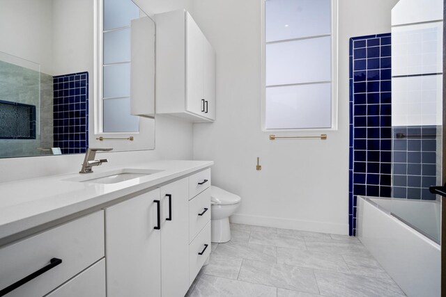 4803 120th St, Lubbock, TX 79424 - full bathroom with vanity, toilet, washtub / shower combination, baseboards, and marble look tile flooring